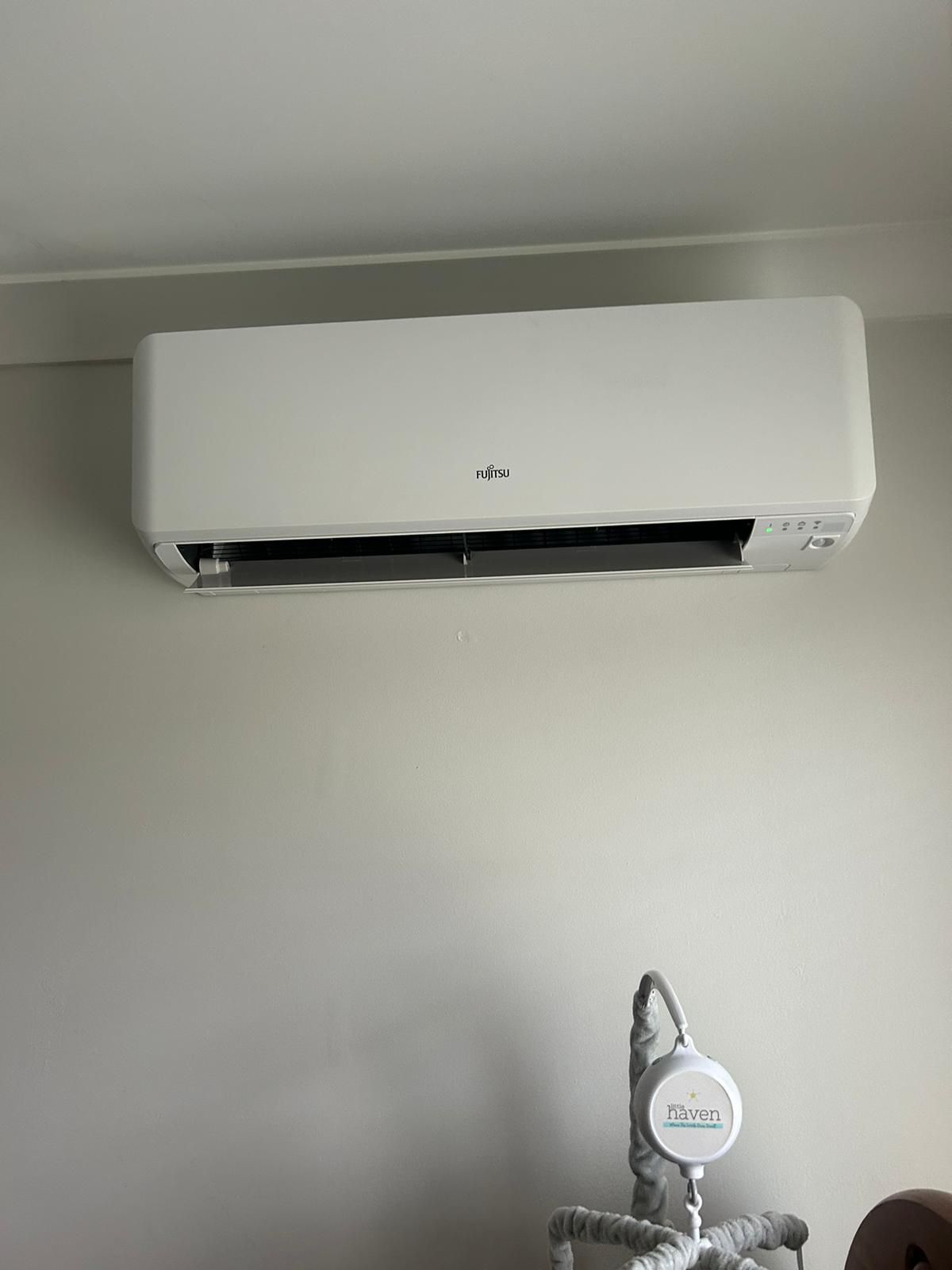 Fujitsu wall-mounted indoor split system head installed cleanly in bedroom